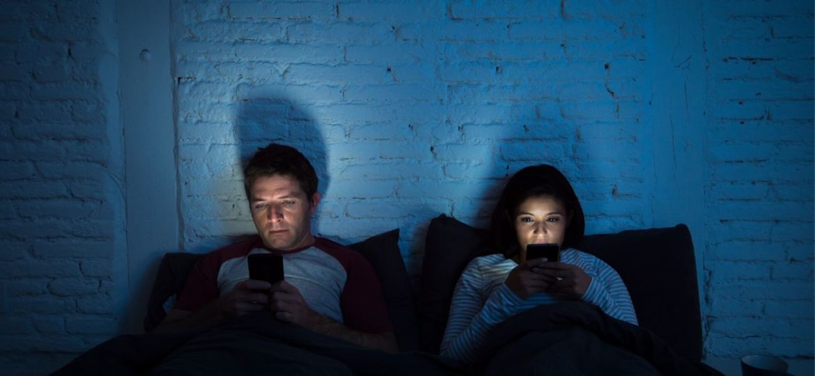 couple in the dark on cell phones communicating